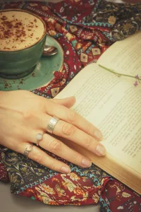 Ring Set On Hand With Coffee Cup and Book In The Background - Fox And Moon Jewellery - Product Photography