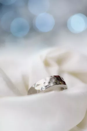 Wedding Ring With White Soft Fabric Background And Bokeh Effect