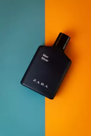 Perfume Bottle Flatlay On Orange and Teal Background